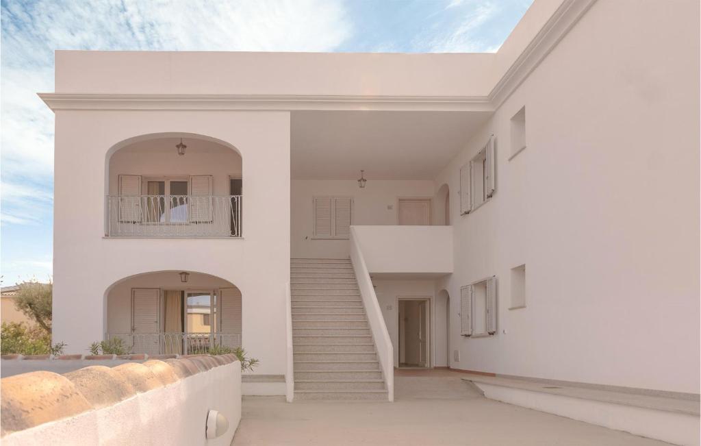 a white house with white stairs and a stair case at Bilo 4 in Orosei