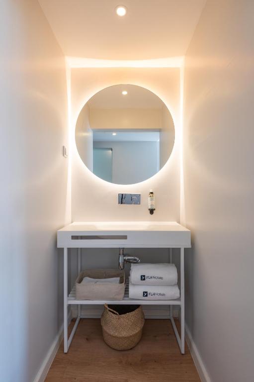 a bathroom with a sink and a mirror at Reserva FLH Hotels Ericeira in Ericeira