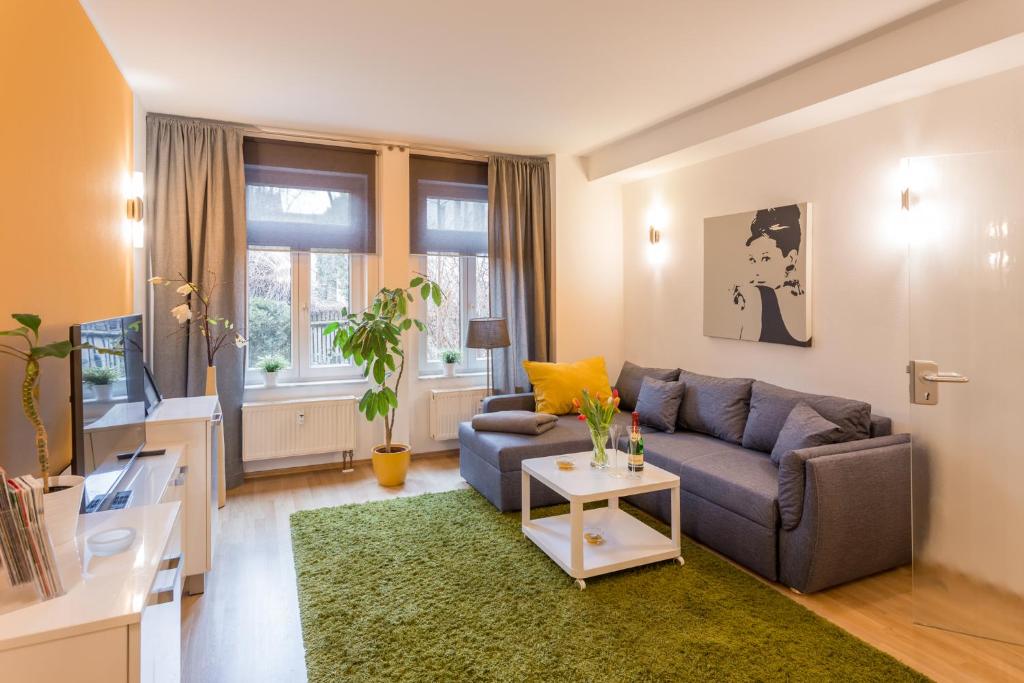 a living room with a couch and a table at Apartment 1, Rothenburger Straße in Dresden