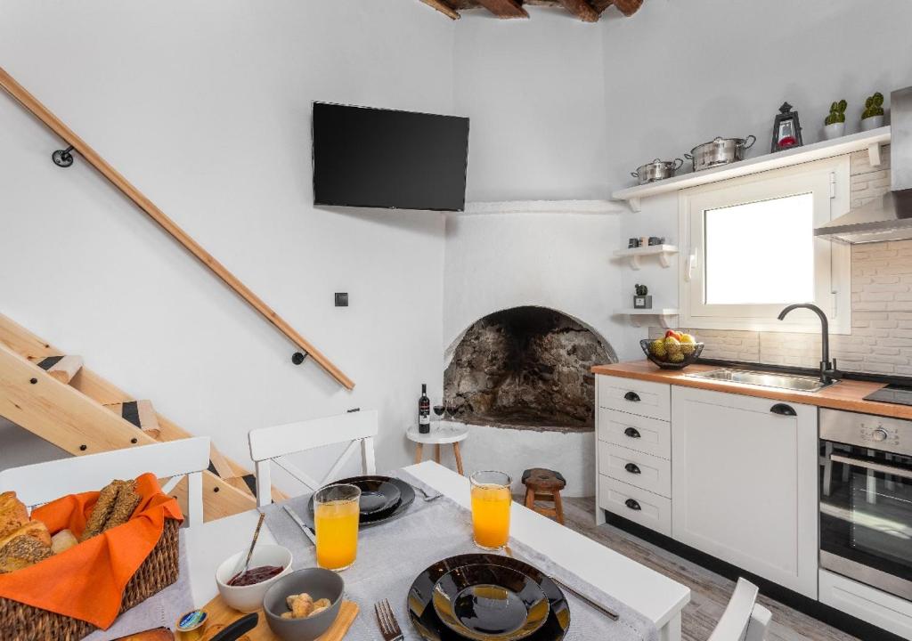 a kitchen with a table with glasses of orange juice at Lotza Traditional House Salakos in Sálakos