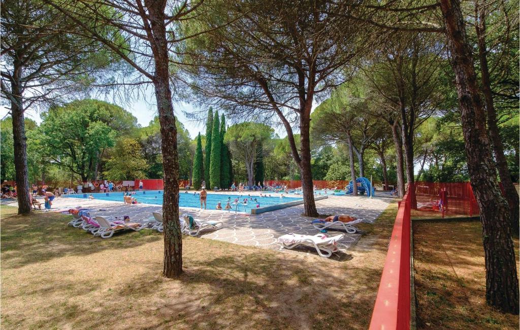 a large swimming pool with people in a park at Novamiramare 4 in Belvedere