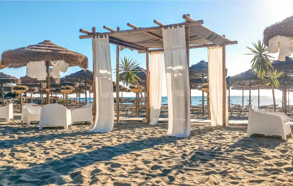a wedding altar on a beach with chairs and umbrellas at Villa 6 in Villaputzu