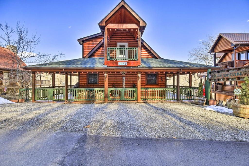 a large wooden house with a balcony on a driveway at 'River Dream Cabin' on New River w/ Fire Pit in Piney Creek