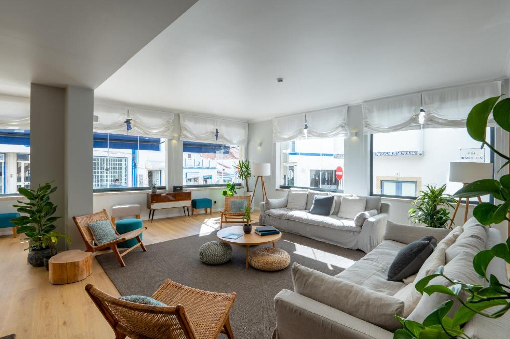 a living room with couches and chairs at Reserva FLH Hotels Ericeira in Ericeira