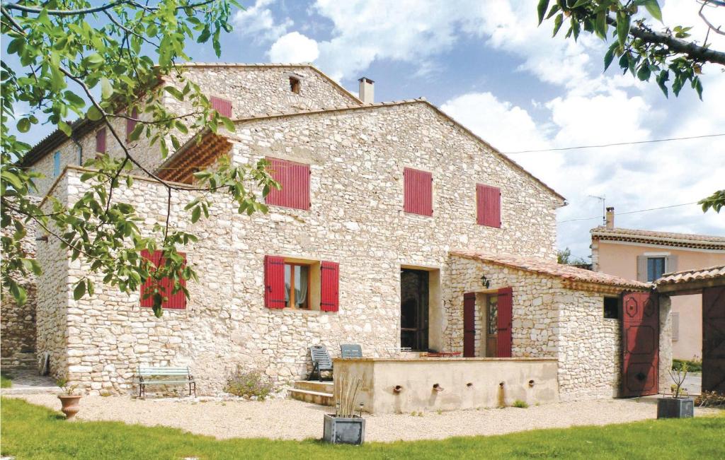 an old stone house with red shutters at Nice Home In Mthamis With 7 Bedrooms in Méthamis