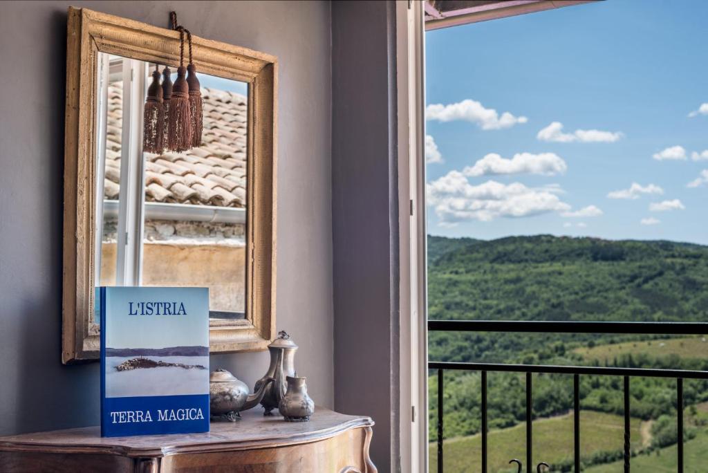 a room with a window with a view of a mountain at Birdhouse in Motovun