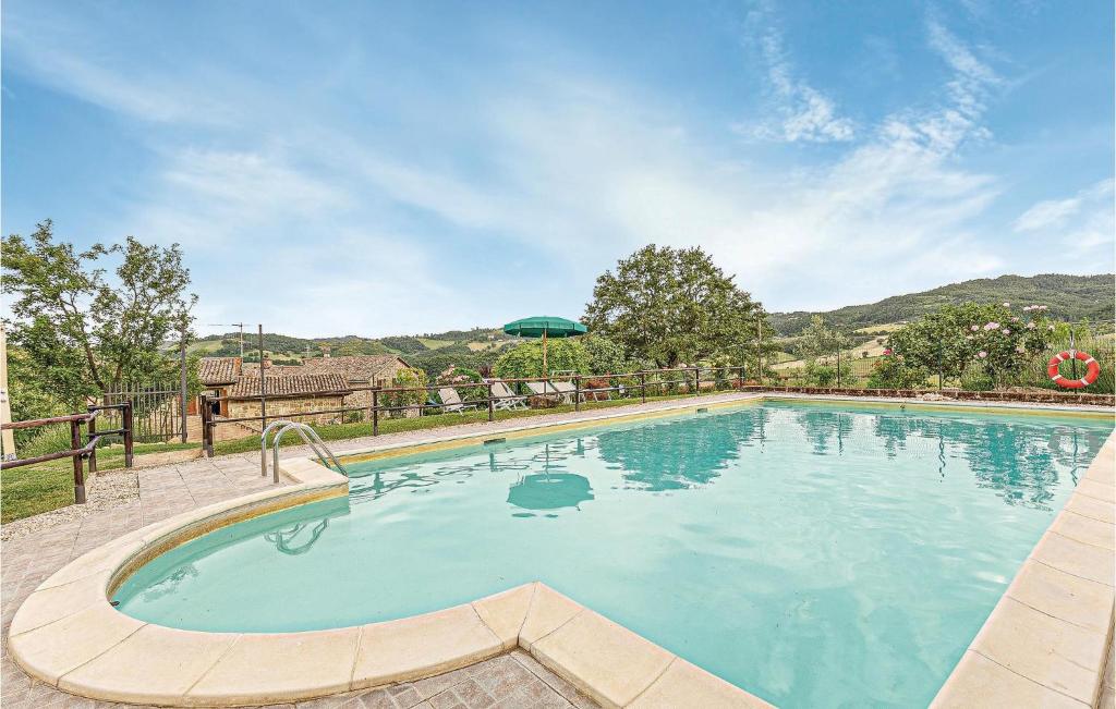 a large swimming pool with blue water at Ginestre 3 in Mengara