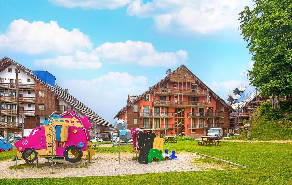 a playground in a park next to some buildings at Borgo Stalle Trilo L29 in Frabosa Sottana