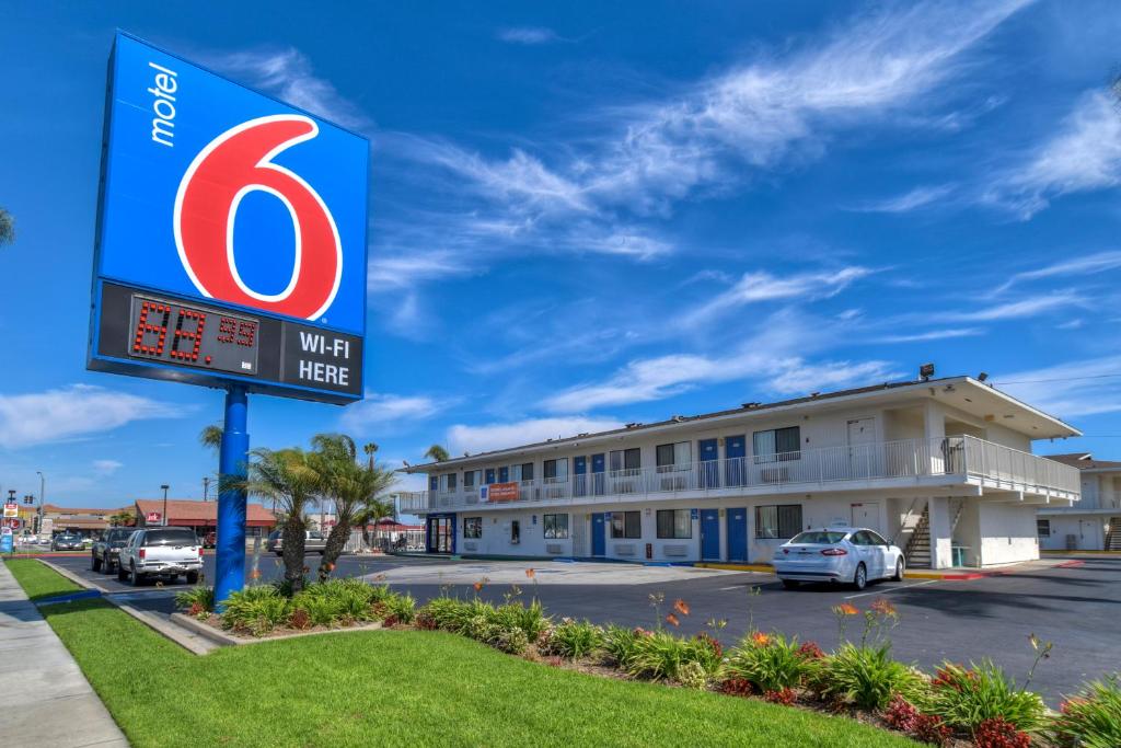 a sign for a hotel in a parking lot at Motel 6-Stanton, CA in Stanton