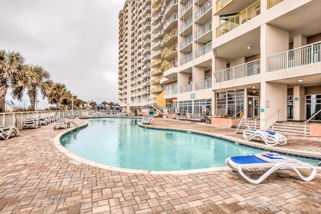 a swimming pool in front of a building at Oceanfront N Myrtle Beach Condo with Hot Tub! in Myrtle Beach