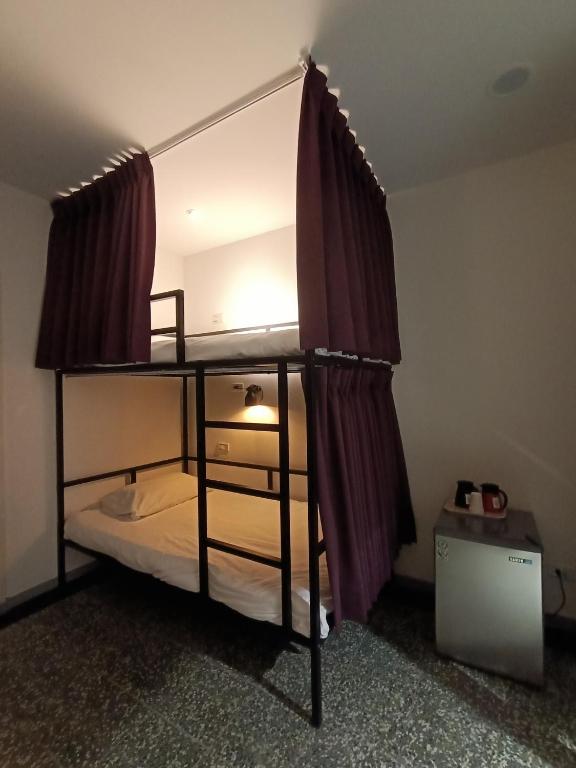 Postel nebo postele na pokoji v ubytování SWF hotel 淡水新五福旅館-新北市旅館編號067