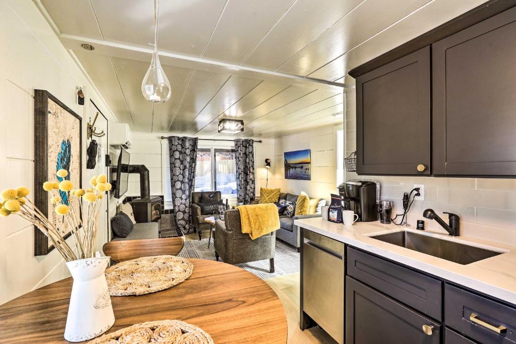 a kitchen and living room with a table and a sink at Cozy Zephyr Cove Cabin, Walk to Lake Tahoe! in Zephyr Cove