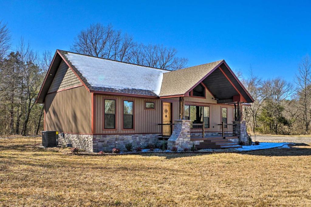 a small house with snow on the roof at Ouachita Mtn Home Near ATV and Hiking Trails! in Big Cedar