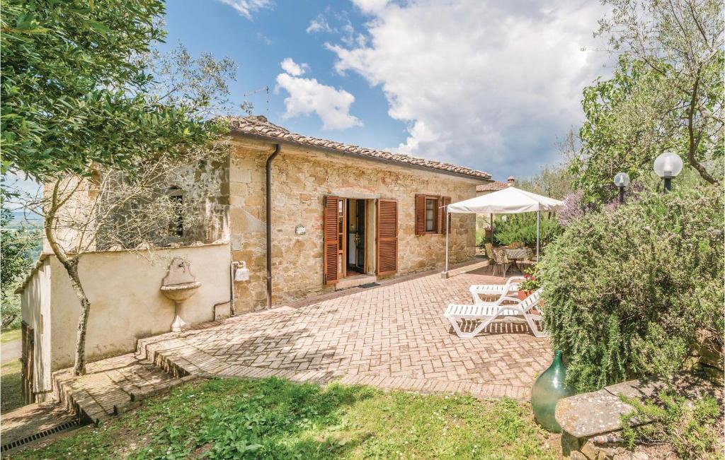 an external view of a stone house with a patio at La Casina Civitella in Pieve a Maiano