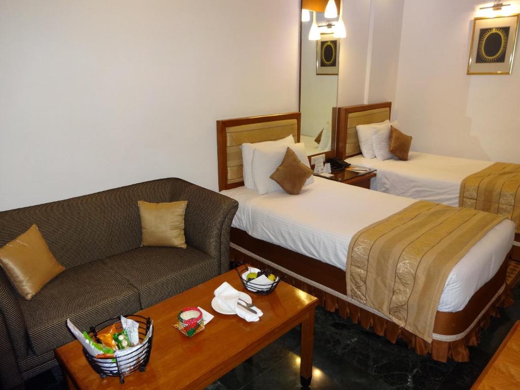 Postel nebo postele na pokoji v ubytování Regency Madurai by GRT Hotels