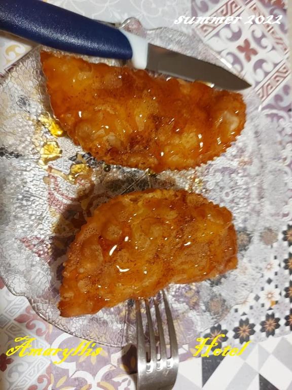two pieces of food on a plate with a fork at Amaryllis Hotel in Karpathos