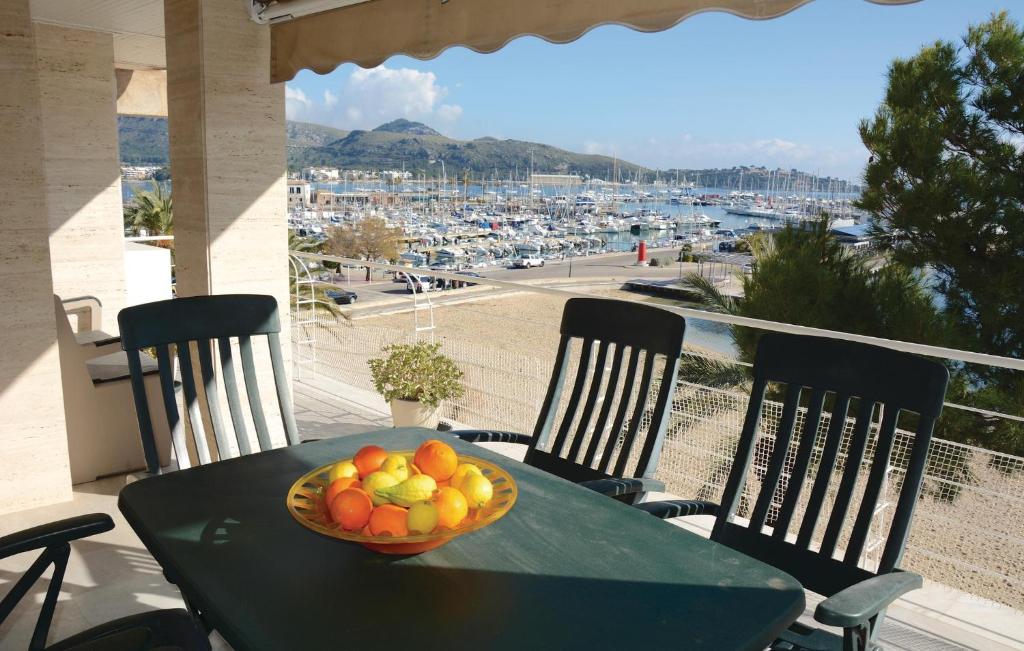 a bowl of fruit on a table with a view of a harbor at Nice Apartment In Port De Pollença in Port de Pollensa