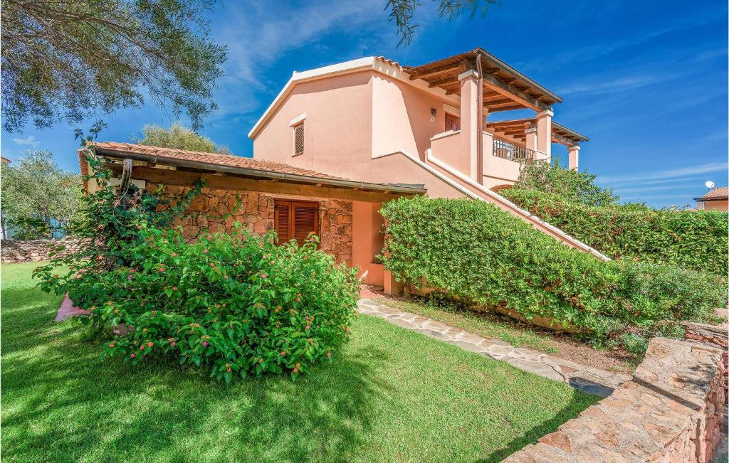 a house with a green yard in front of it at Trilo 6 in San Teodoro