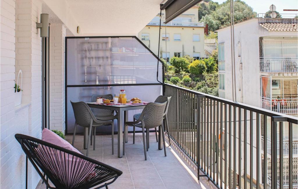 a balcony with a table and chairs on it at Amazing Apartment In Tossa De Mar With Kitchen in Tossa de Mar