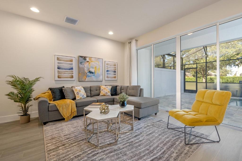 a living room with a couch and chairs at Hidden Forest 3 Bedroom Vacation Townhome with pool -2020 in Clermont
