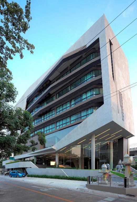 a large building with a car parked in front of it at Nine Forty One Hotel in Bangkok