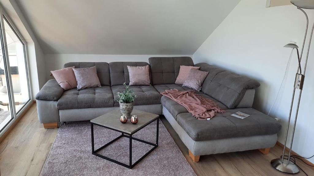 a living room with a couch and a chair at Ferienwohnung Storchennest in Itzgrund-Kaltenbrunn in Kaltenbrunn