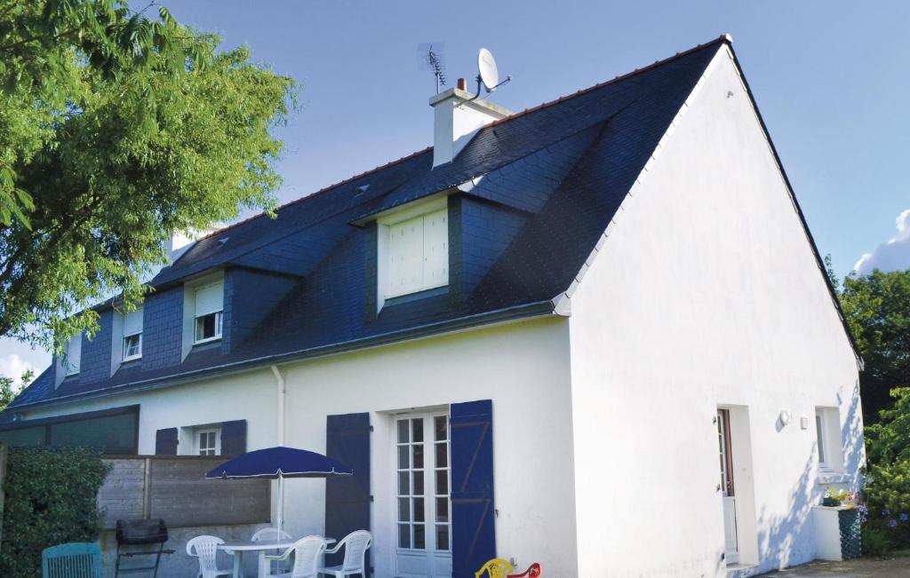 a white church with a blue roof and a cross on top at Nice Home In Pleuven With Wifi in Pleuven