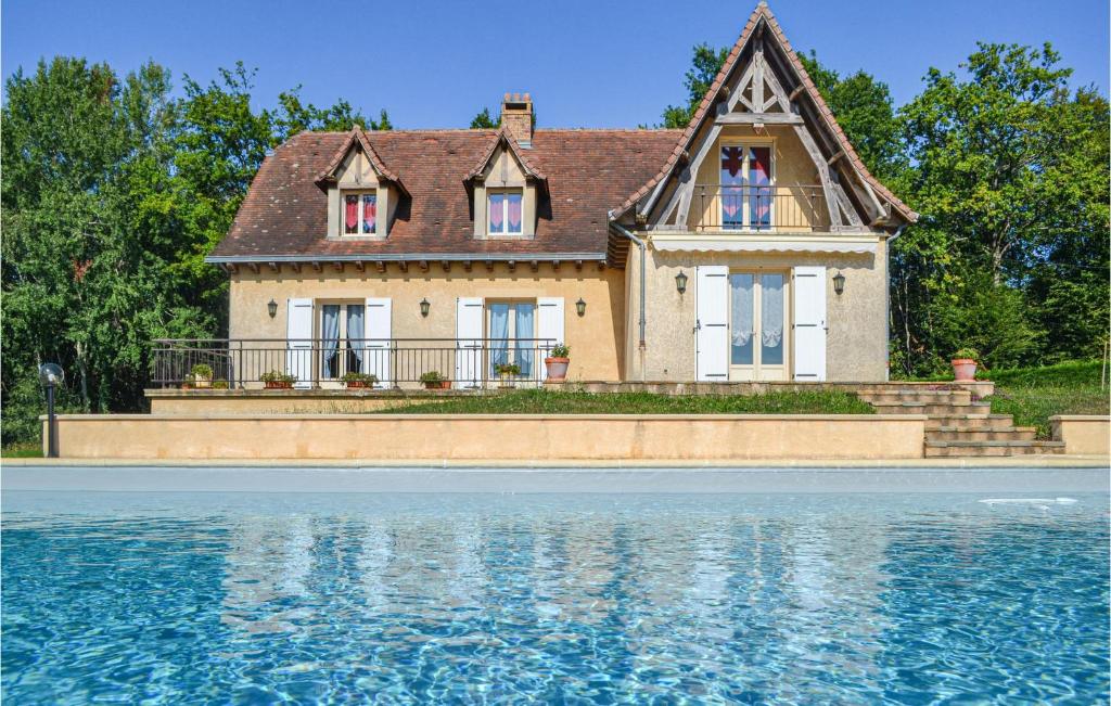 a house next to a body of water at Lovely Home In Savignac-Ledrier in Payzac