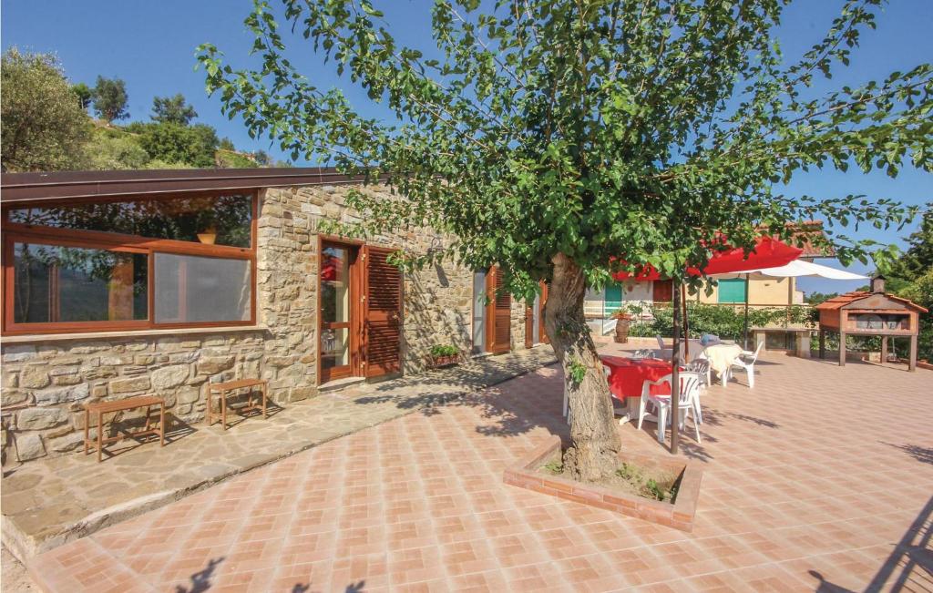 a stone house with a tree in front of it at Villa Marisa in Perdifumo