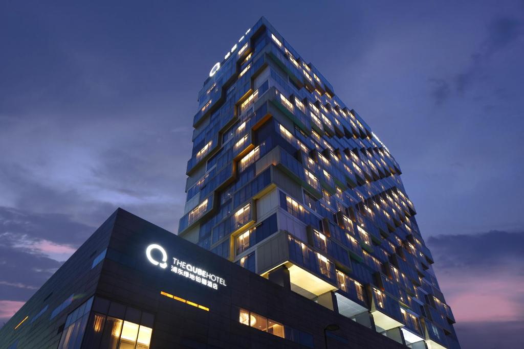 a building with a sign on the side of it at The QUBE Hotel Shanghai – Pudong International Airport in Shanghai