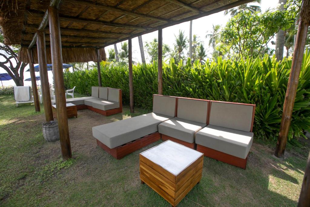 a group of couches and tables under a gazebo at Baía Branca Beach Resort in Tamandaré