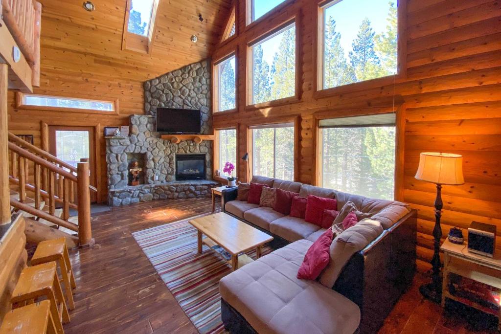 a living room with a couch and a fireplace at Home with Indoor Pool in South Lake Tahoe! in South Lake Tahoe