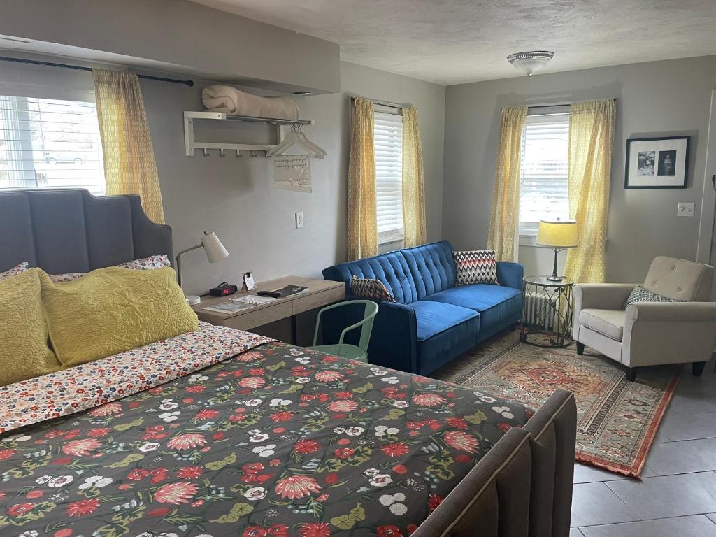 a bedroom with a bed and a living room at Modern Homestead Guest House in Reedsville