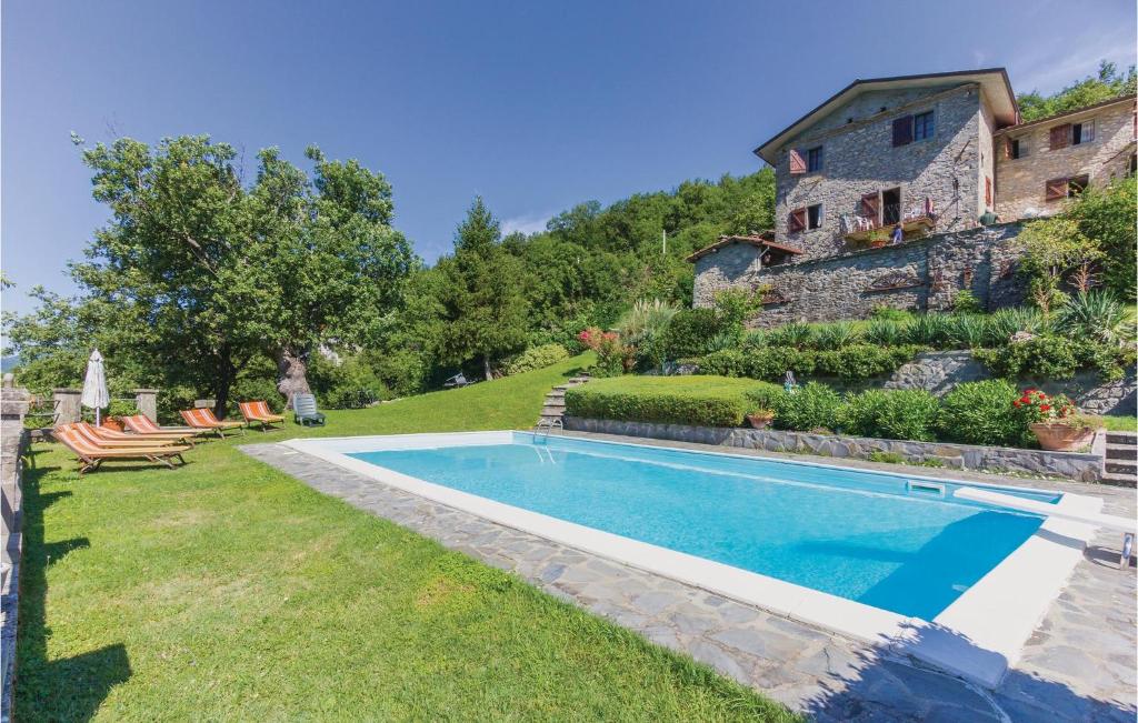 a swimming pool in the yard of a house at Casa Lina in Comano