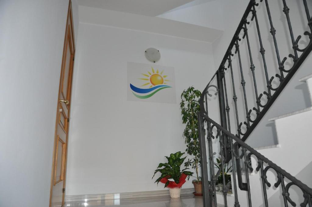 a staircase with a sun wall sticker on the wall at Domus Primavera in Scerne