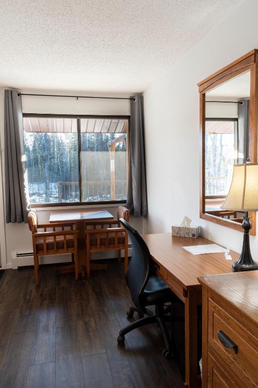 an office with a desk and a chair and a window at Schott's Lake Conference & Resort in Sundre