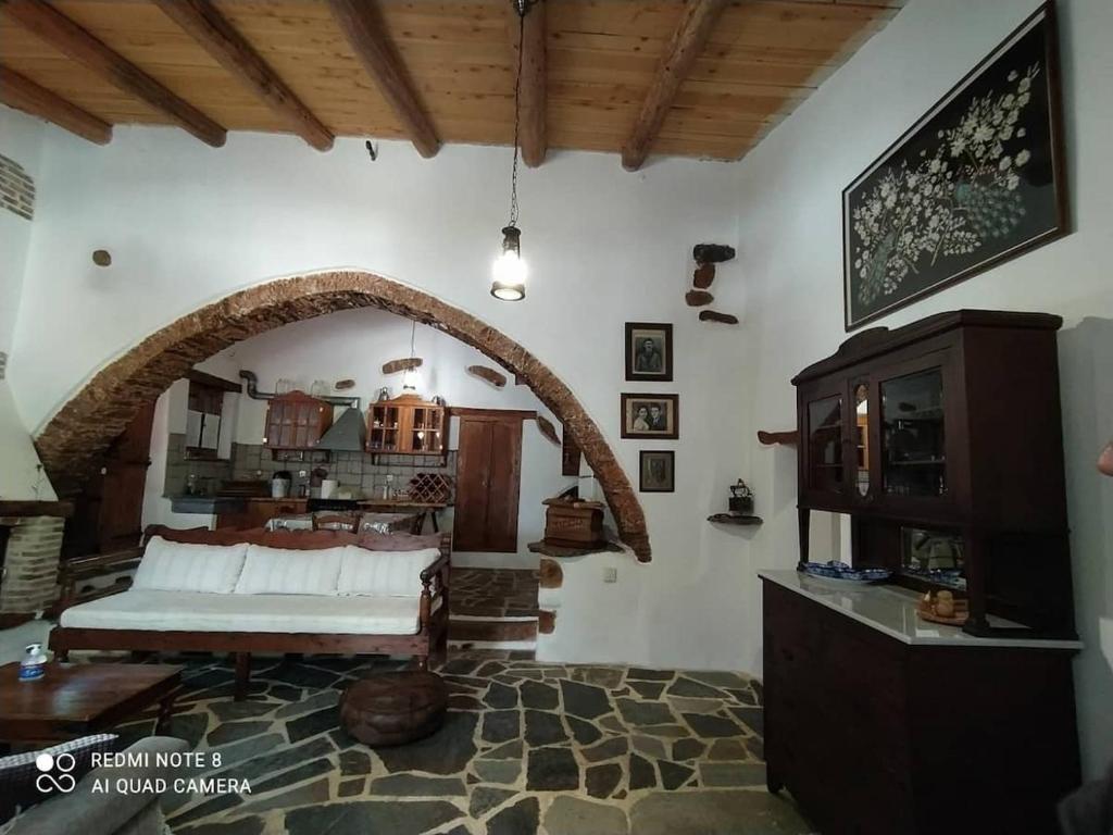 ein Schlafzimmer mit einem Bett und einem Torbogen in der Unterkunft Afrodite's House-Restaurated Oil Factory in Ayiá