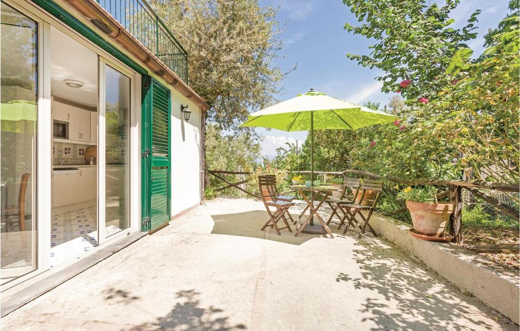 a patio with a table and an umbrella at Villa Dellolivo in Sorrento