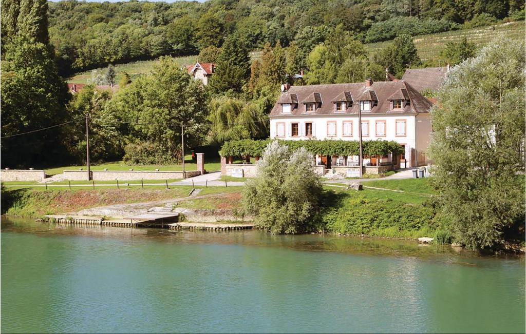 a large house on the side of a river at 4 Bedroom Gorgeous Home In Jaulgonne in Jaulgonne
