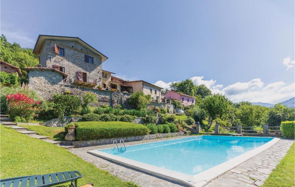 a swimming pool in a yard next to a house at Casa Lina in Comano