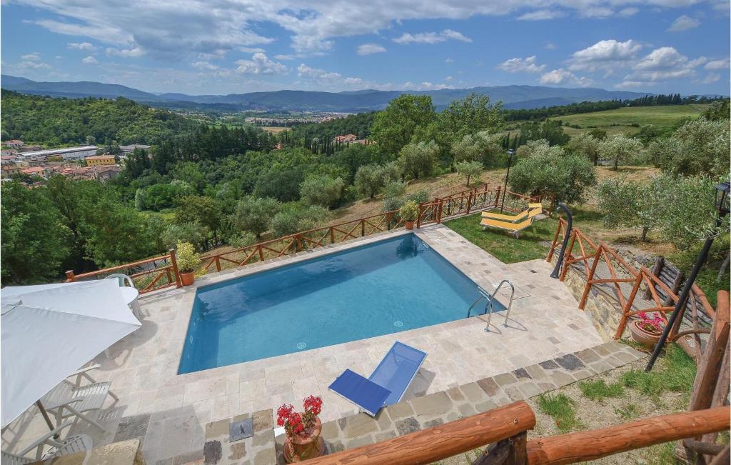 a swimming pool with two chairs and an umbrella at Casa Di Vigna Rosa in Serravalle