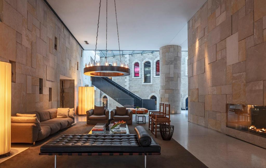 a living room with a couch and a fireplace at Mamilla Hotel in Jerusalem