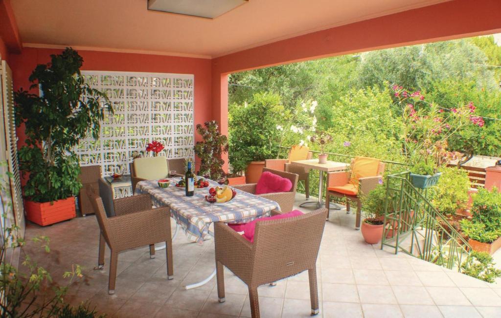 a patio with a table and chairs and plants at Stunning Home In Artemida With 3 Bedrooms And Wifi in Artemida