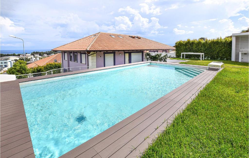 a swimming pool in the backyard of a house at Villetta Il Mirto in Belladonna