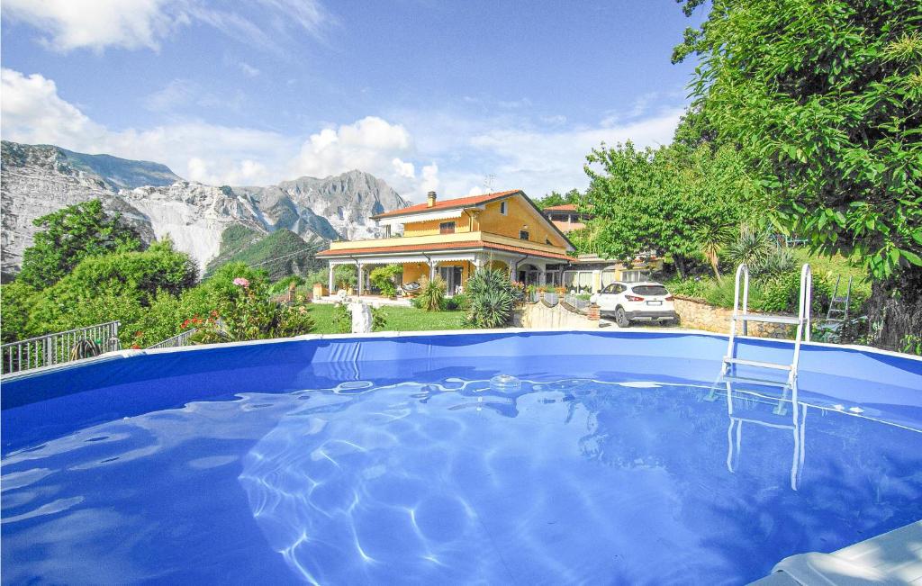a house with a swimming pool in front of a house at Beautiful Home In Codena With Jacuzzi in Carrara