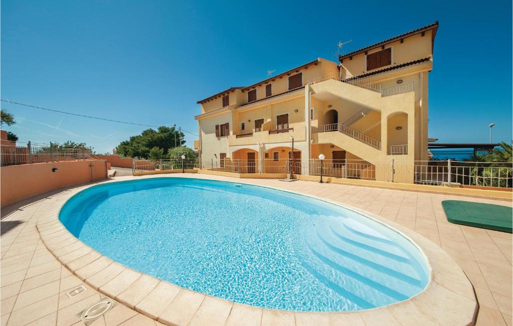 a large swimming pool in front of a building at Lotar in Castelsardo