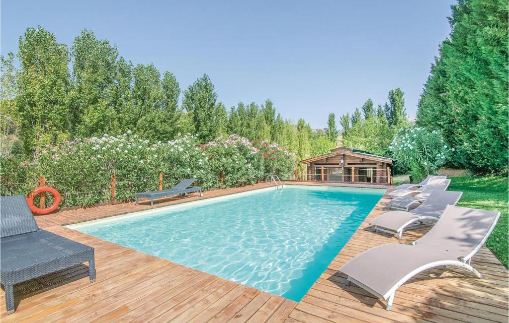 a swimming pool with chairs and a gazebo at Casale Orsini in Magliano Sabina