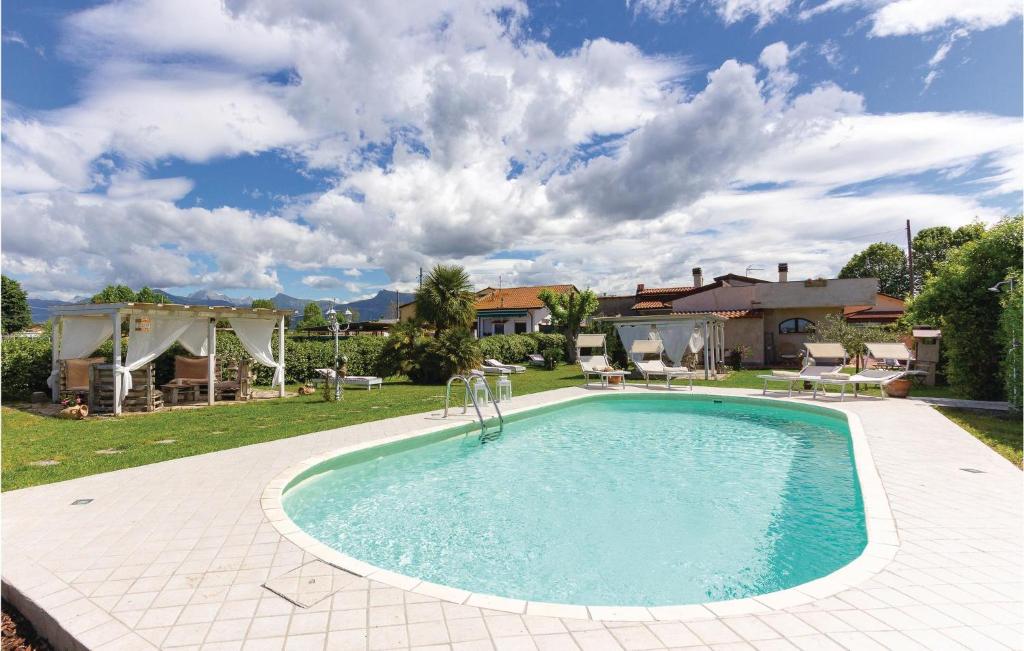 a swimming pool in a yard next to a house at Casa Rebecca in Torre del Lago Puccini