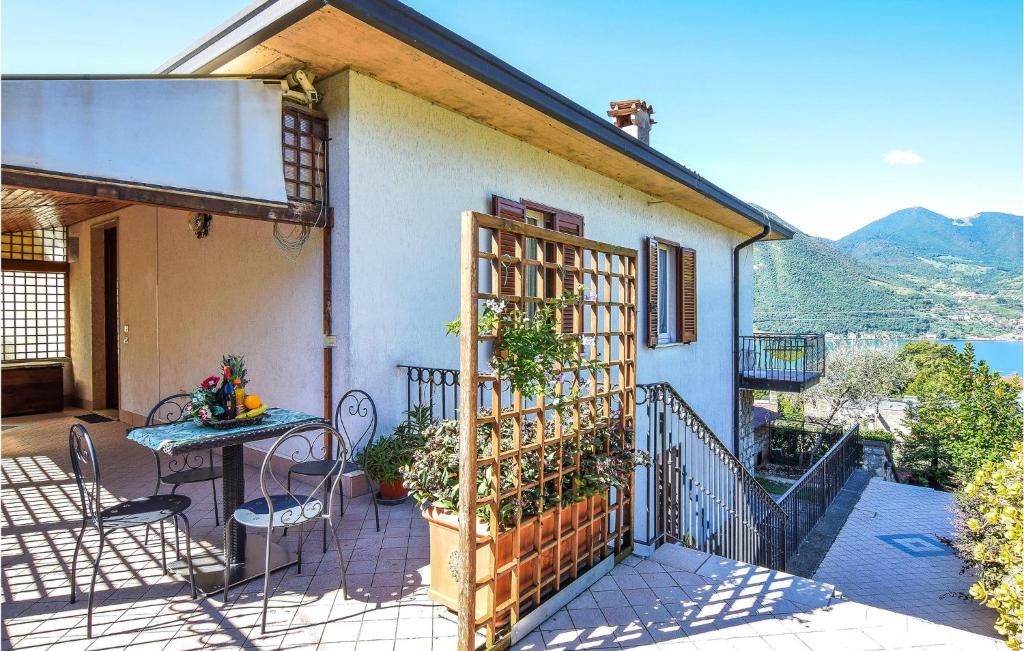 una casa con balcone con tavolo e recinzione di Beautiful Apartment In Monte Isola With 1 Bedrooms And Wifi a Monte Isola