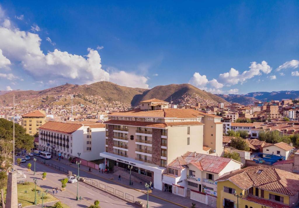 a city with buildings and mountains in the background at Sonesta Hotel Cusco in Cusco